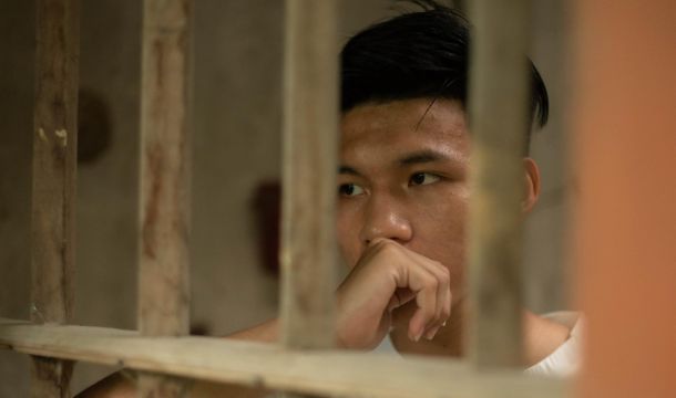 guy in prison cell looking out