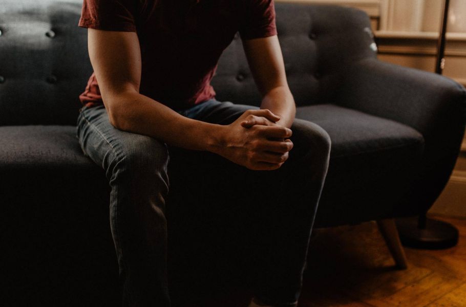 man sitting on coach, indoors