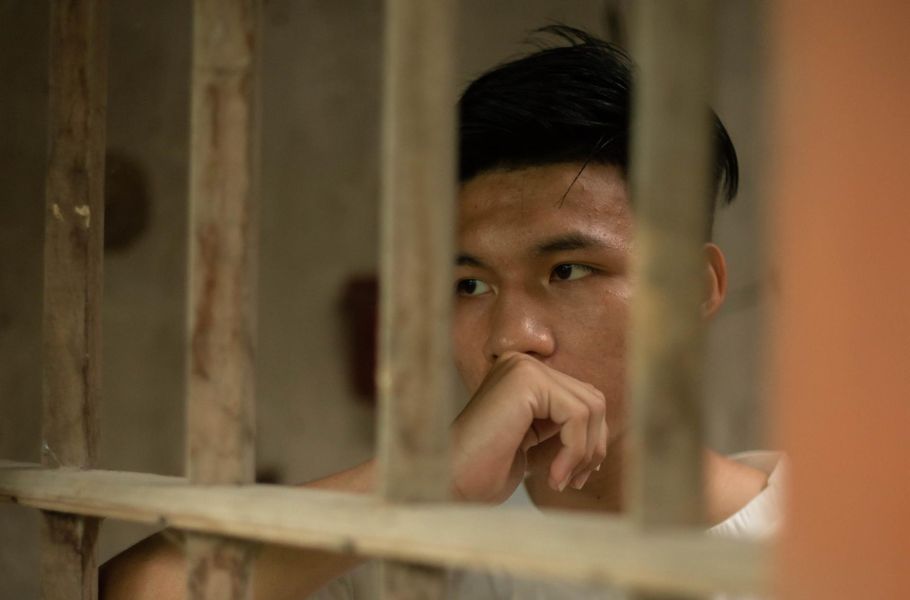 guy in prison cell looking out