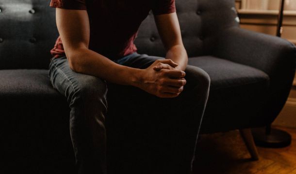 man sitting on coach, indoors